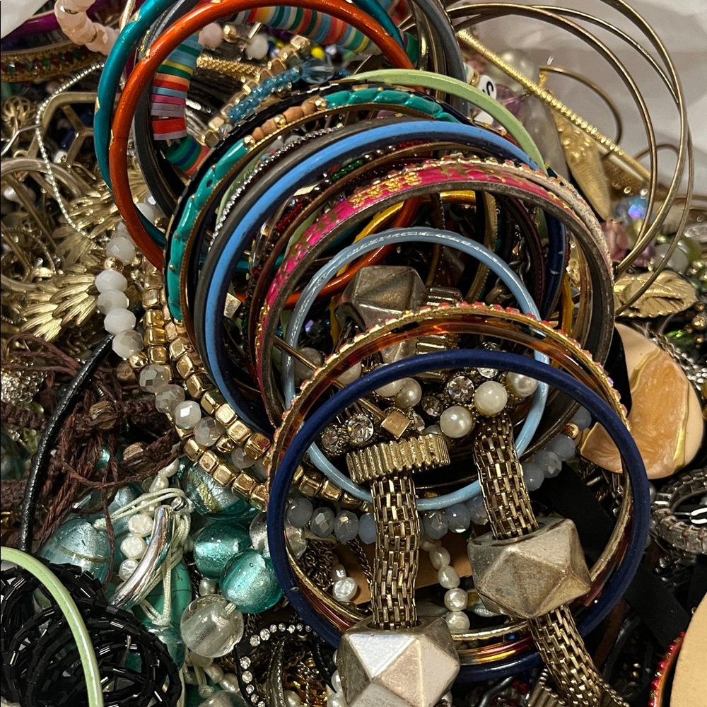 Colorful costume jewelry unchecked. Bangles, necklaces, rings, earrings and more